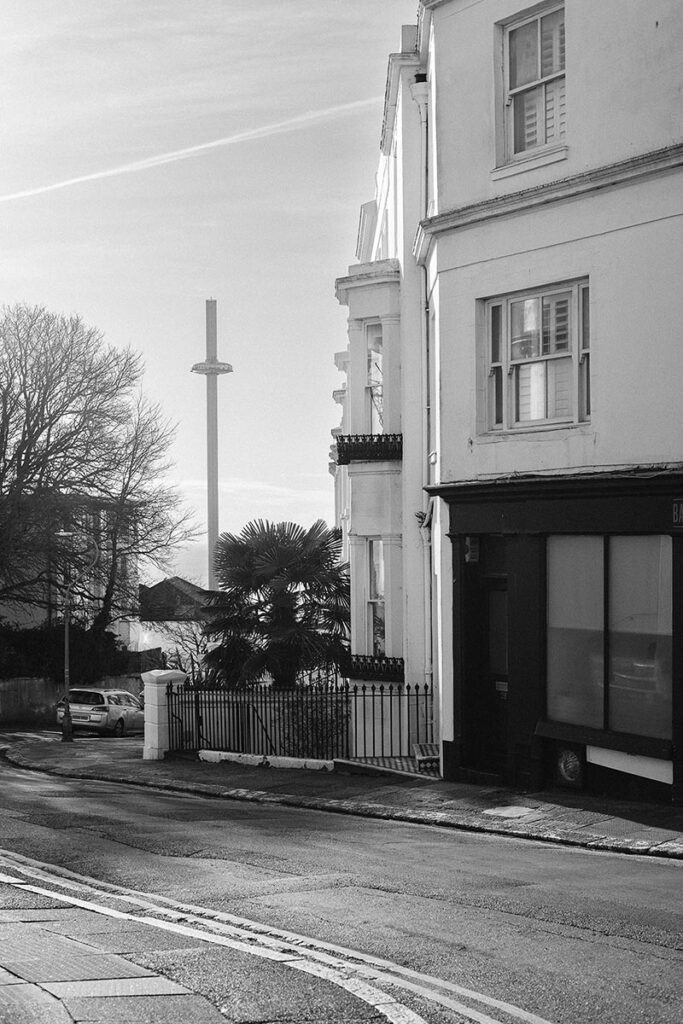 a street scene in Brighton's seven dials with the i360 in the background
