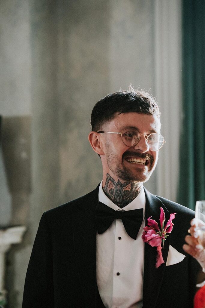 candid image of a groom smiling at his relaxed pub wedding reception, The Joker Brighton