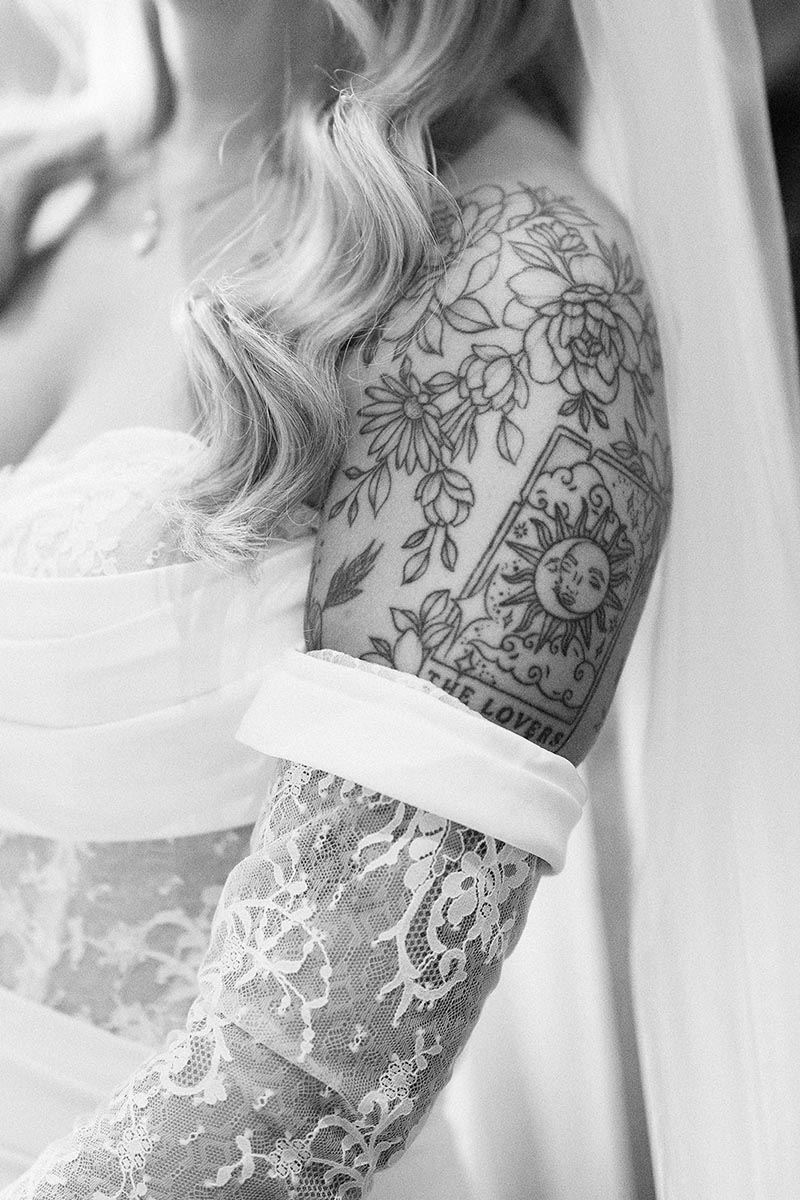 detail of a bride's arm showing her tattoo of The Lovers Tarot card on her wedding day at the joker pub in Brighton