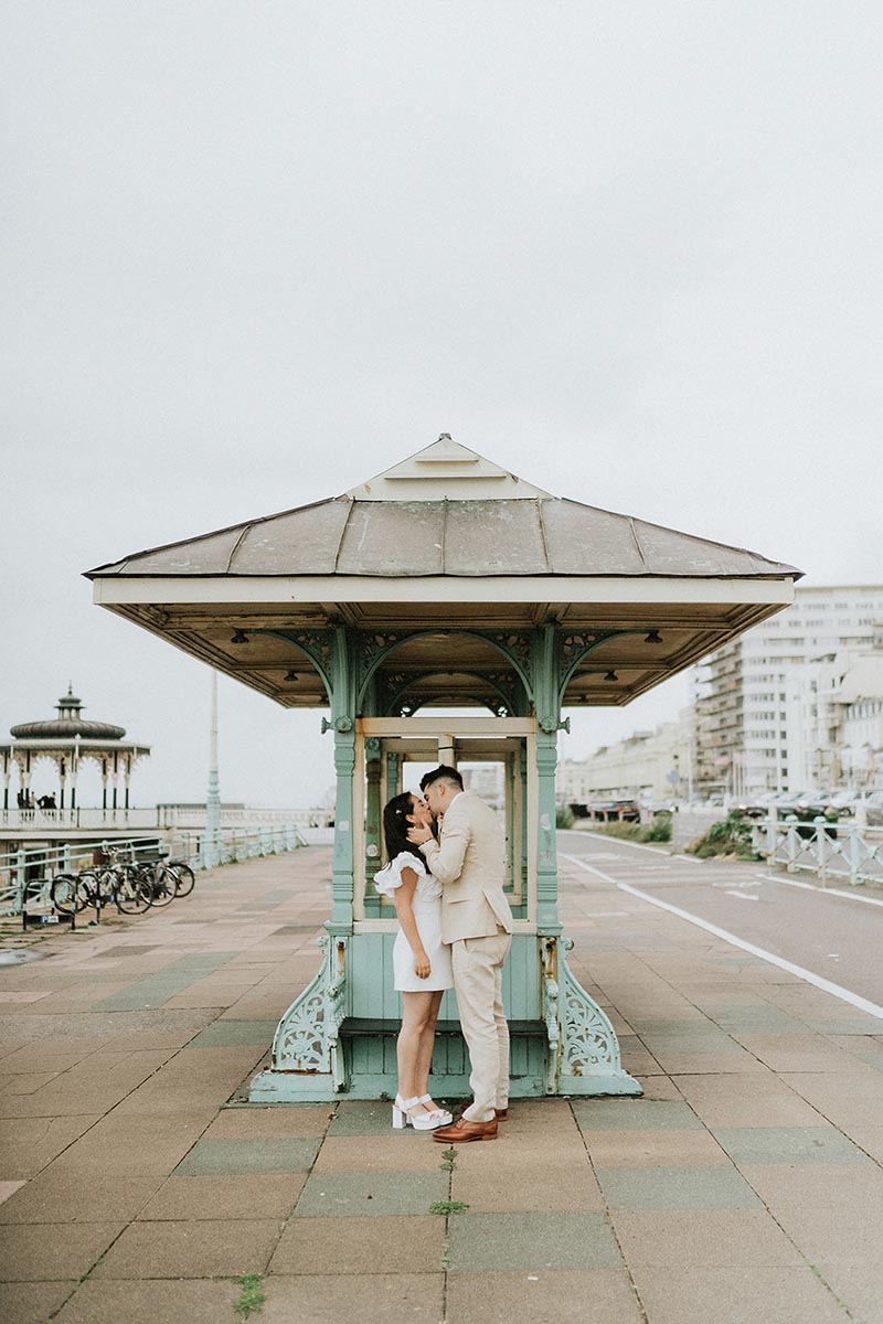 Jasmine + Ross | Brighton Wedding Bride in off-shoulder silk wedding dress stepping out of a London black cab, editorial wedding photography London